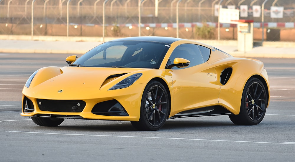 a yellow sports car parked in a parking lot