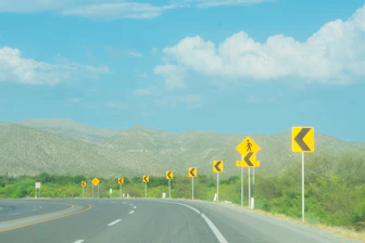 Illustration of colorful traffic signs with simple labels and explanations.