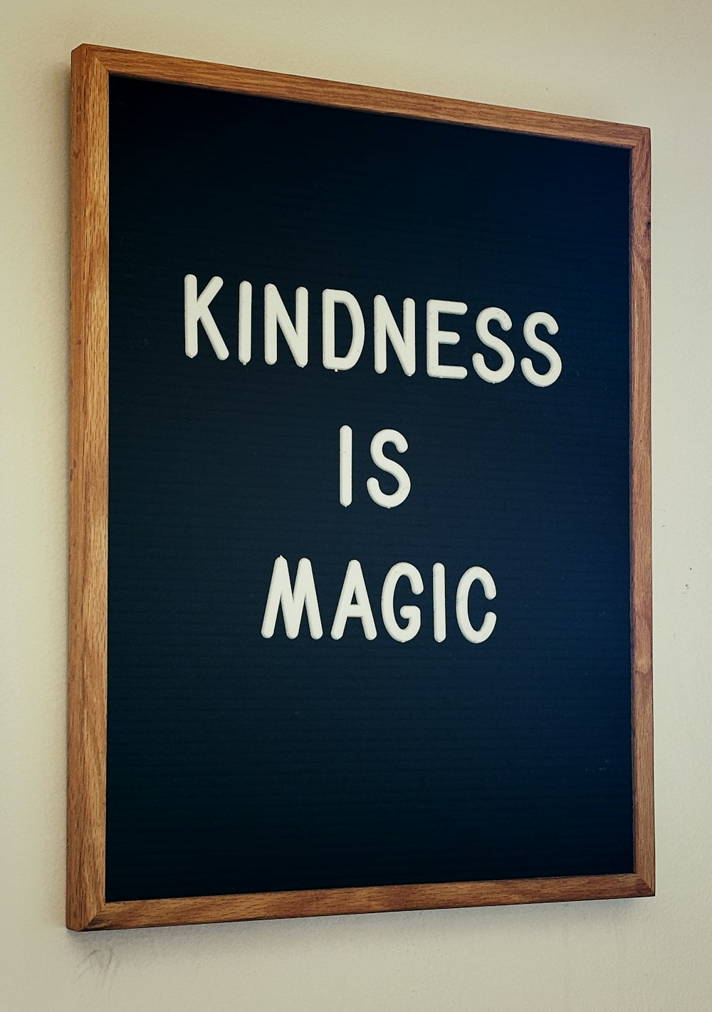 a picture of a sign that says kindness is magic