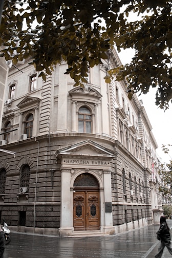 a large building with a wooden door on a city street
