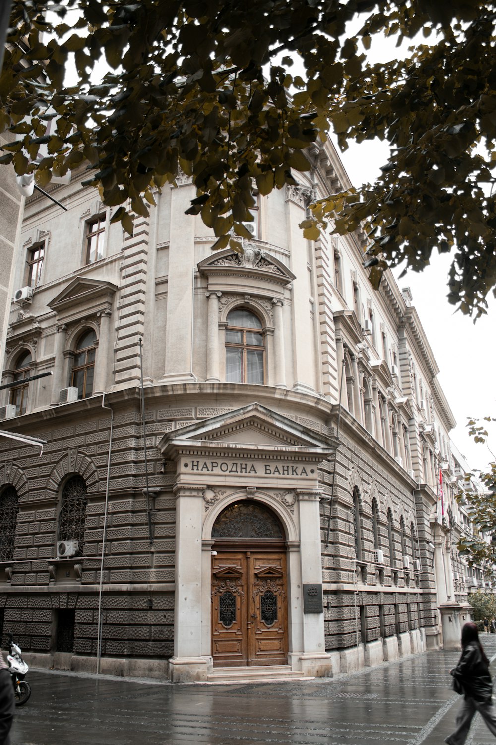 a large building with a wooden door on a city street