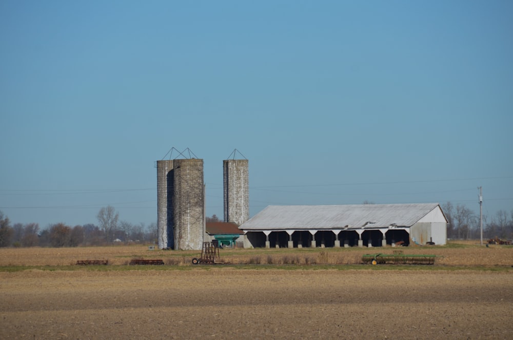 a farm with two silos in the middle of it