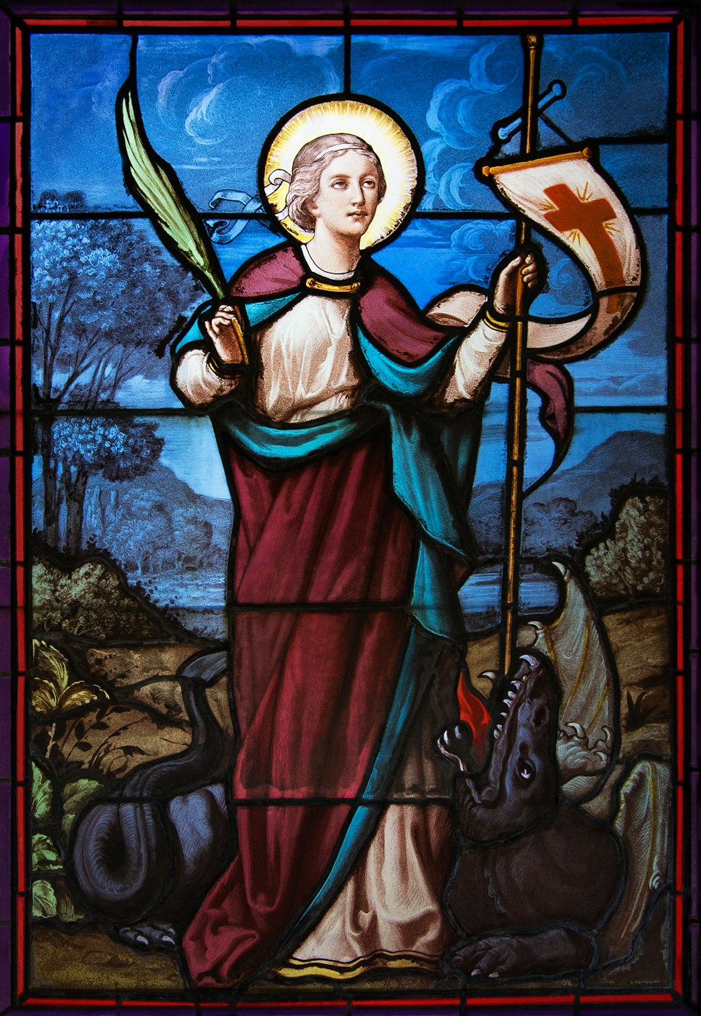 a stained glass window with a woman holding a flag