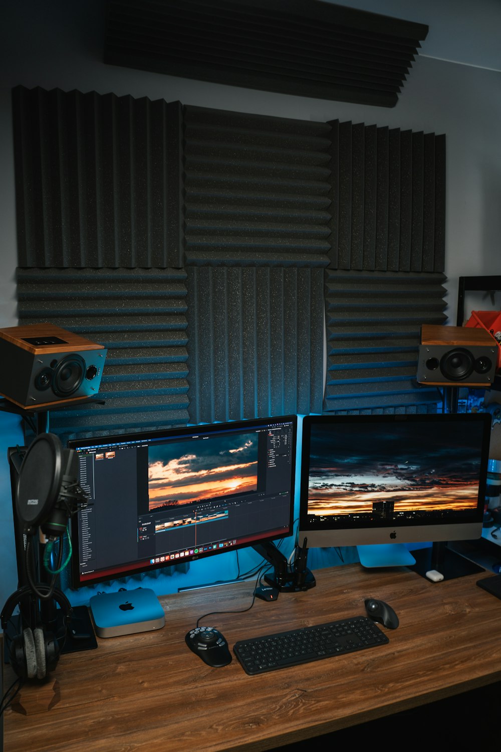 a computer desk with two monitors and a keyboard