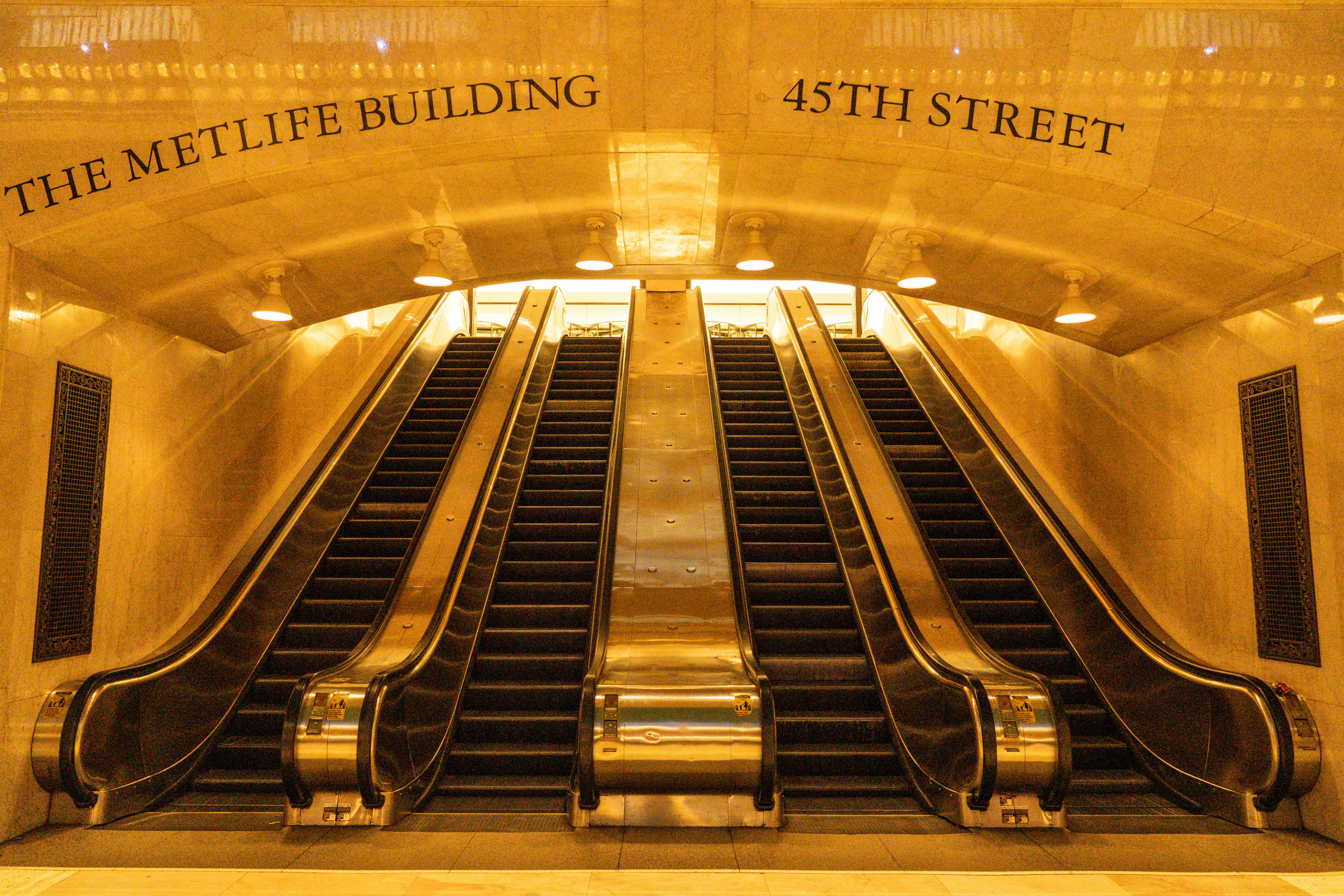 an escalator in a building with a sign that says the metlife building