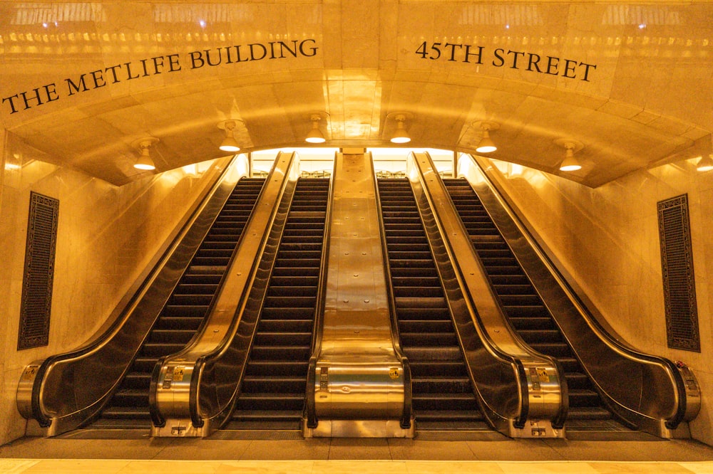 an escalator in a building with a sign that says the metlife building