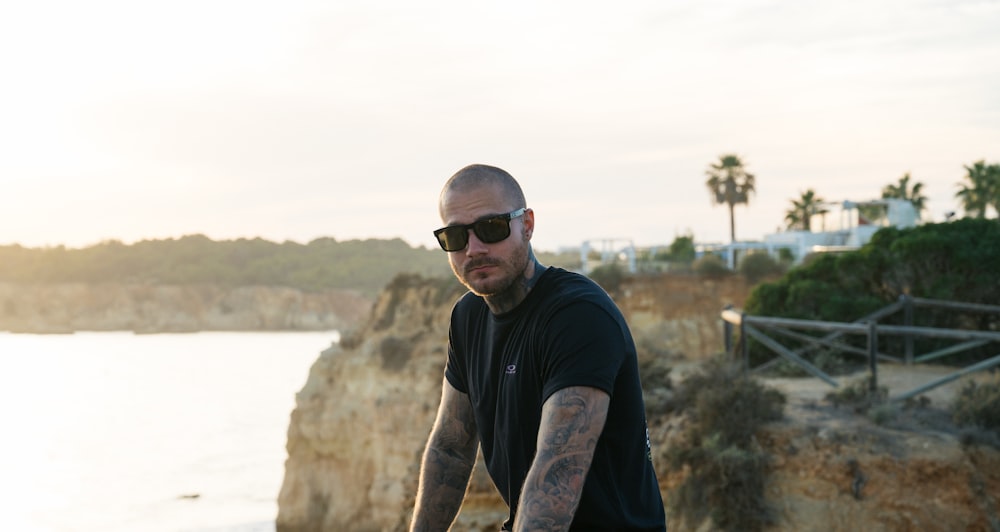 a man riding a bike next to a body of water