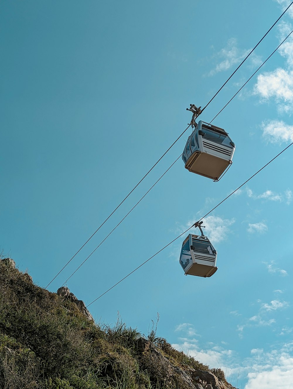 a couple of gondolas sitting on top of a hill