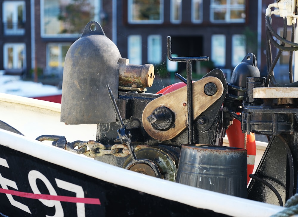 a close up of a boat's engine with a building in the background