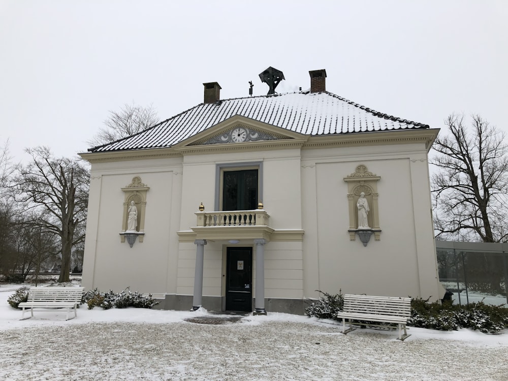 a white building with a clock on the top of it