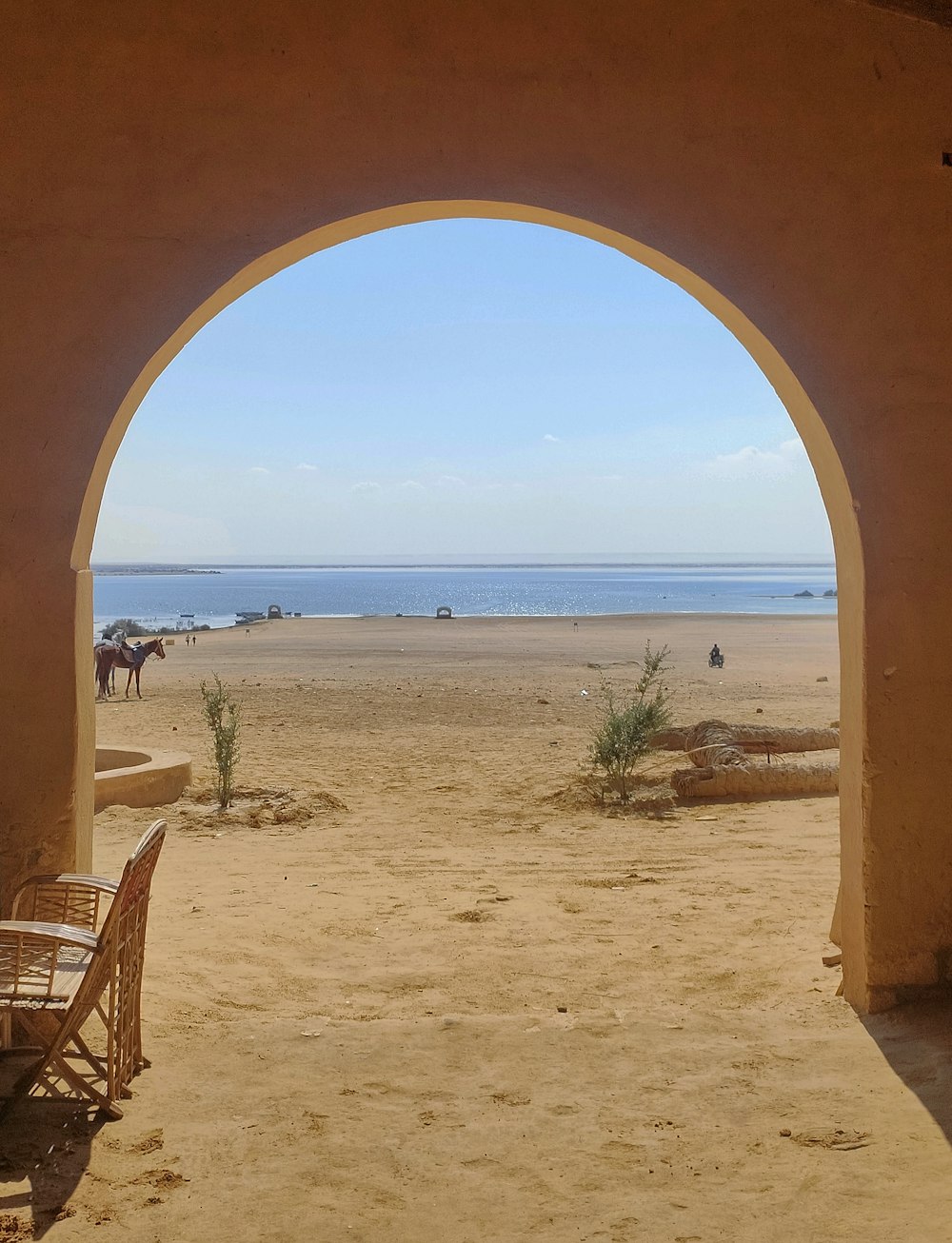 a view of a beach through an archway