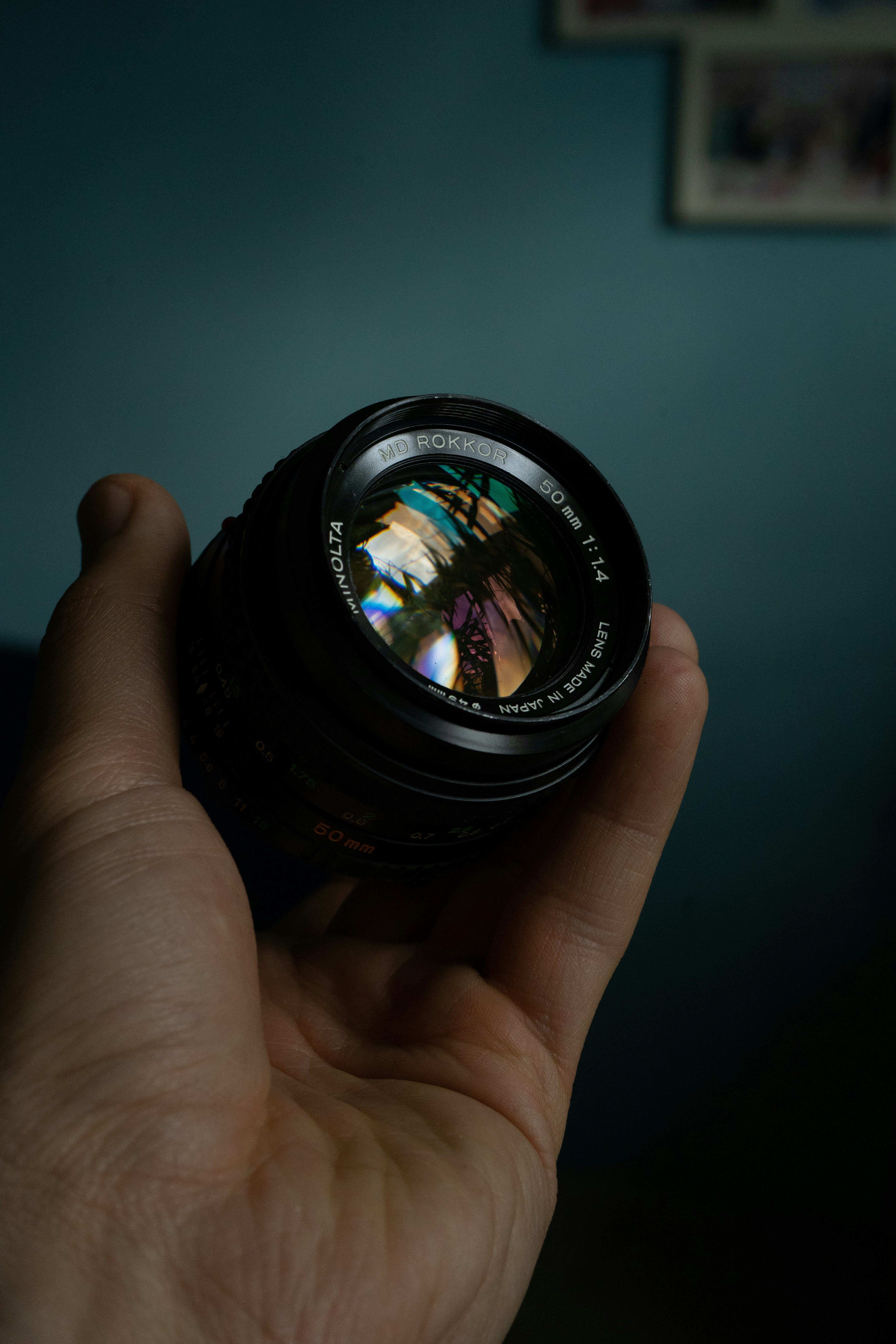 a person holding a camera lens in their hand