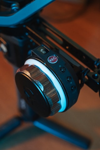 Close-up of a voice logger device with illuminated buttons in a professional setting.