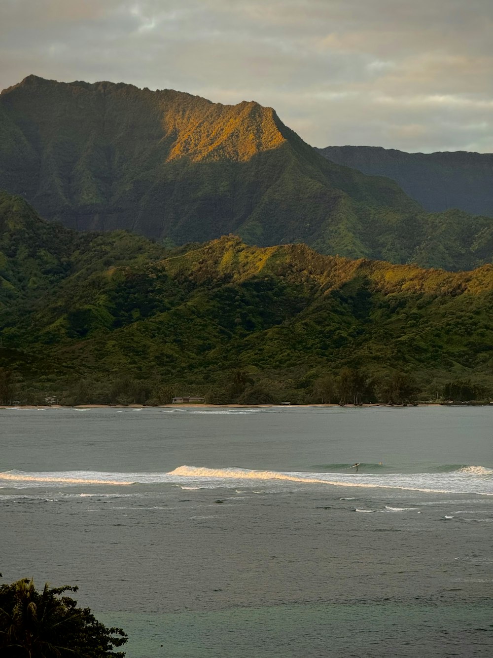 a large body of water with a mountain in the background