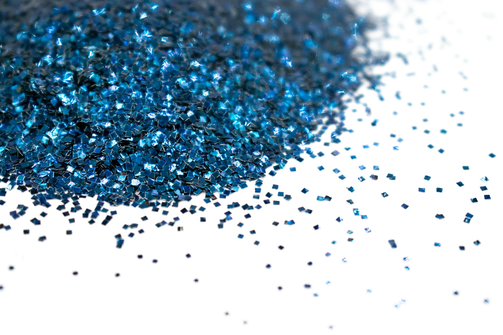 a pile of blue glitter sitting on top of a white table