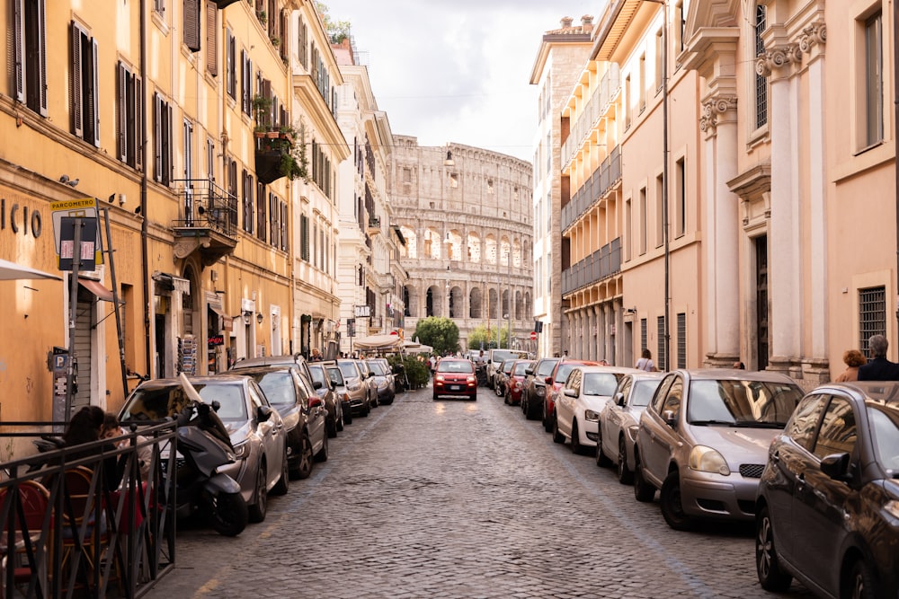 a street lined with parked cars next to tall buildings