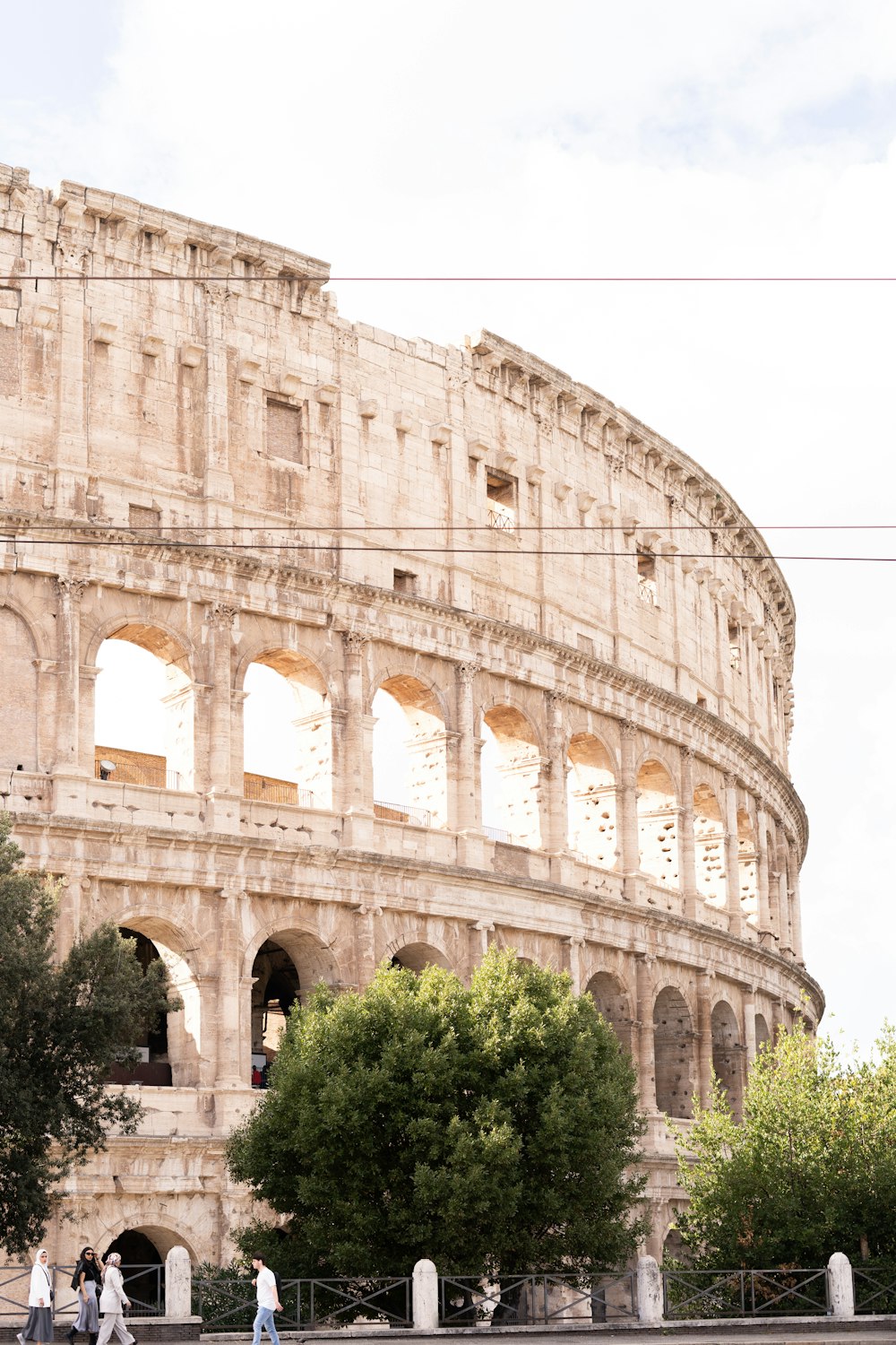 a group of people walking in front of an ancient building