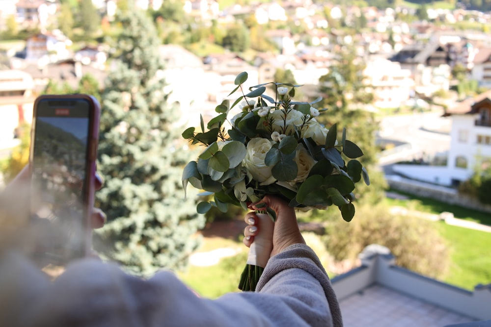 a person holding a bouquet of flowers in their hand