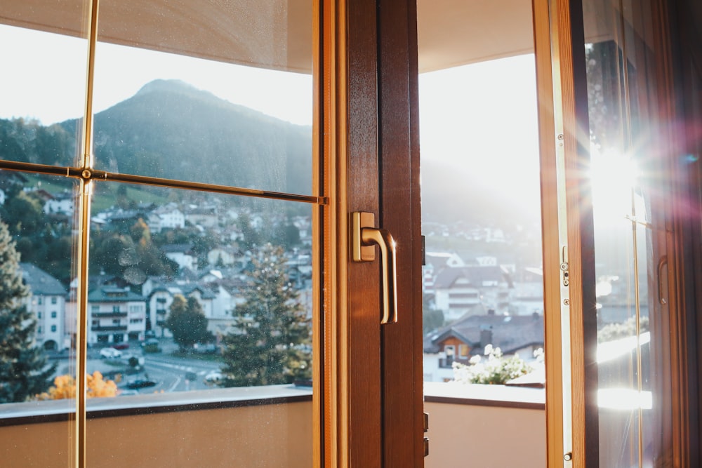 a window with a view of a town and mountains