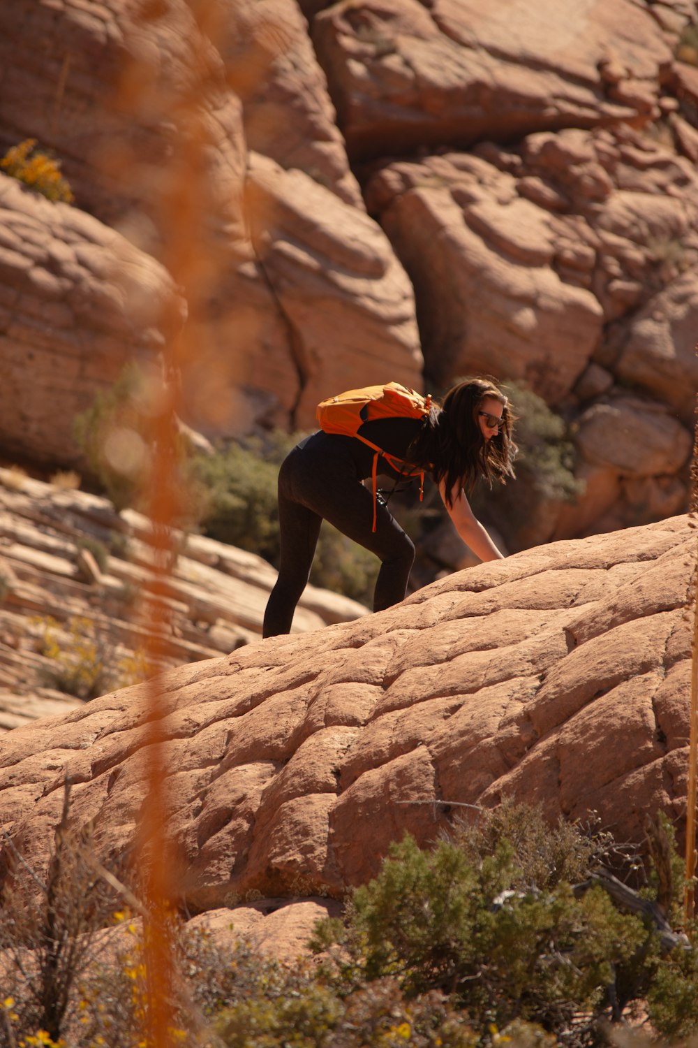 a man climbing up a rock in the desert