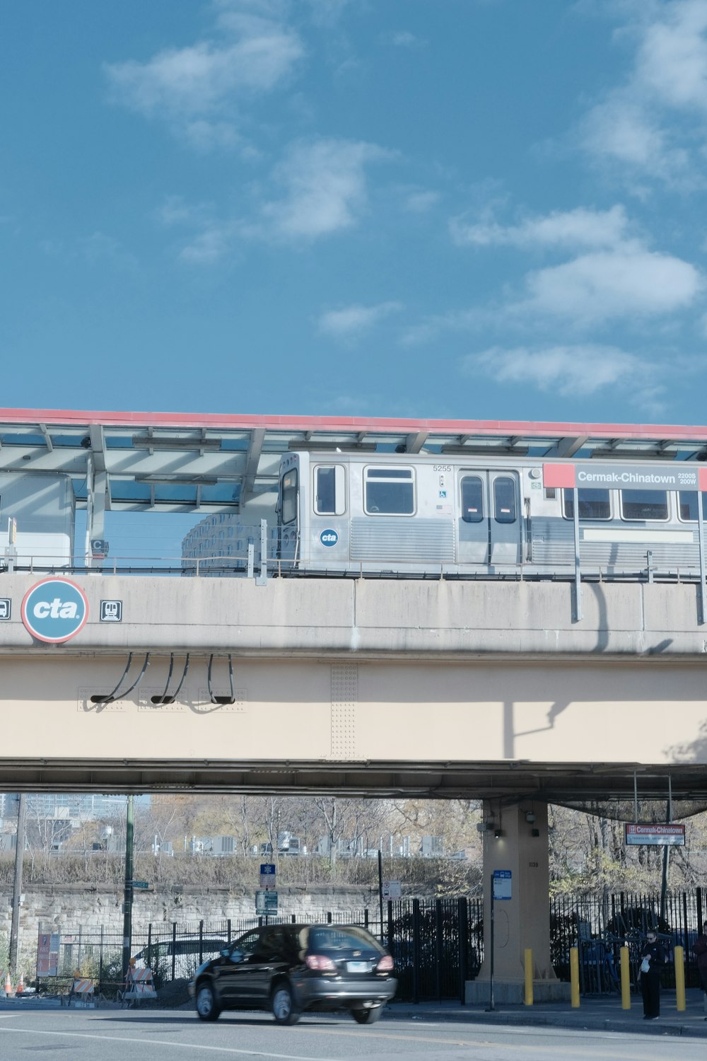 a train traveling over a bridge over a street