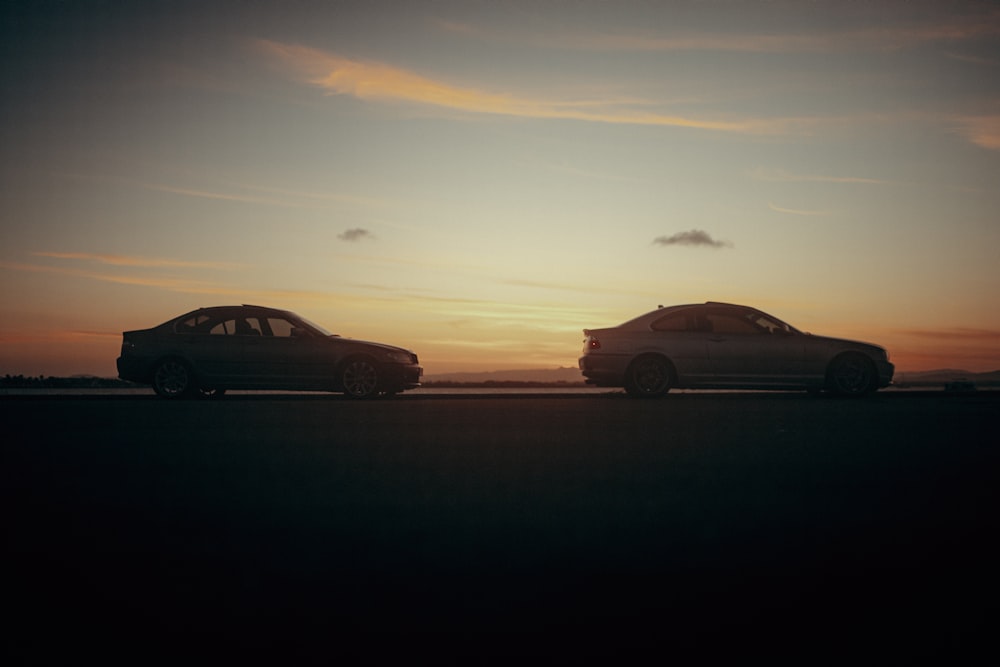 a couple of cars that are sitting in the street