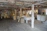 Historic brewery interior with vintage brewing equipment and warm lighting.