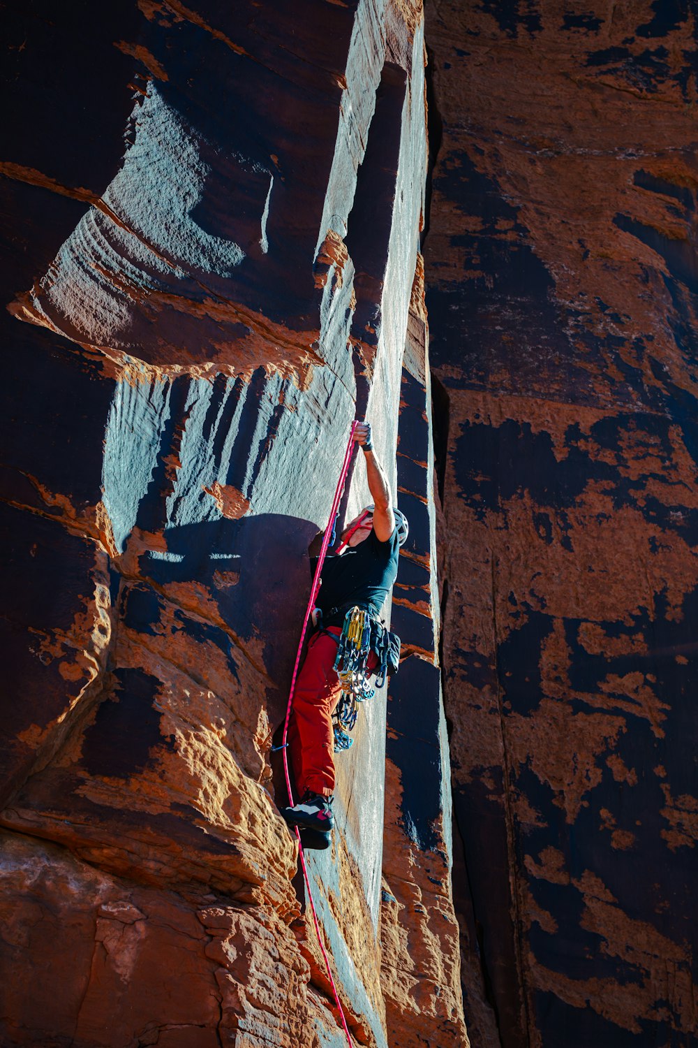 a man climbing up the side of a mountain