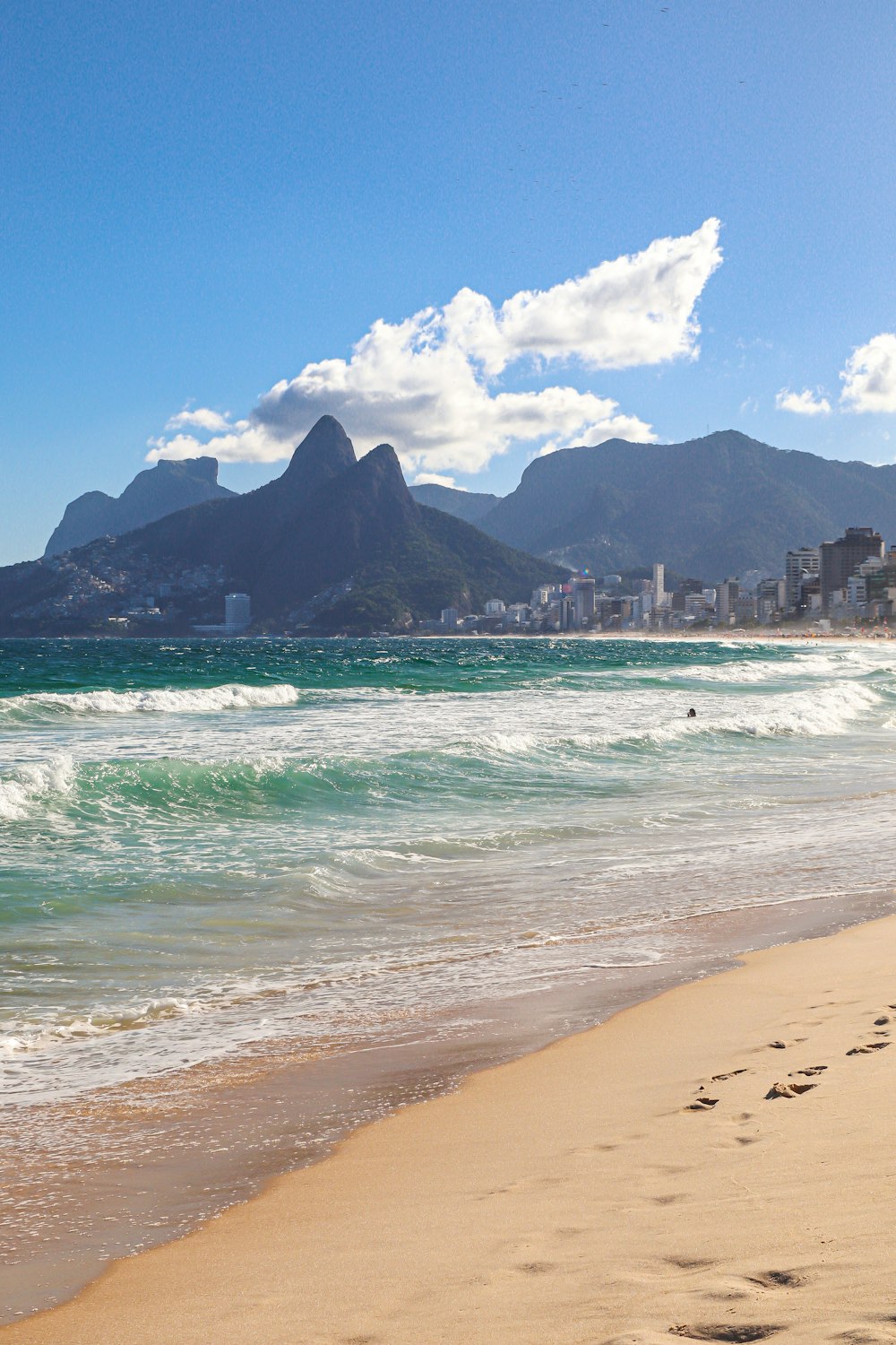 a view of a beach with mountains in the background