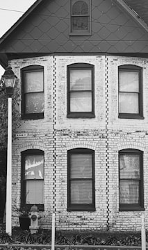 An elegant black and white photo of a home inspector examining a property.