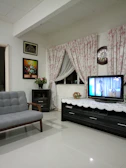 A cozy living room featuring a cream-toned handmade wooden coffee table against a black wall.