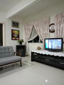 A cozy living room with a TV showing a popular Turkish drama series.