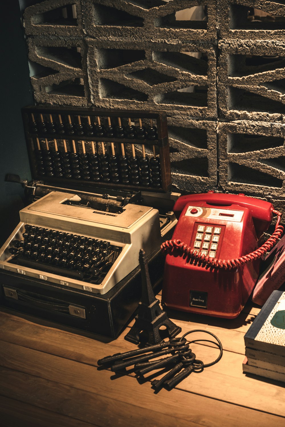 a desk with a typewriter, telephone, and other items
