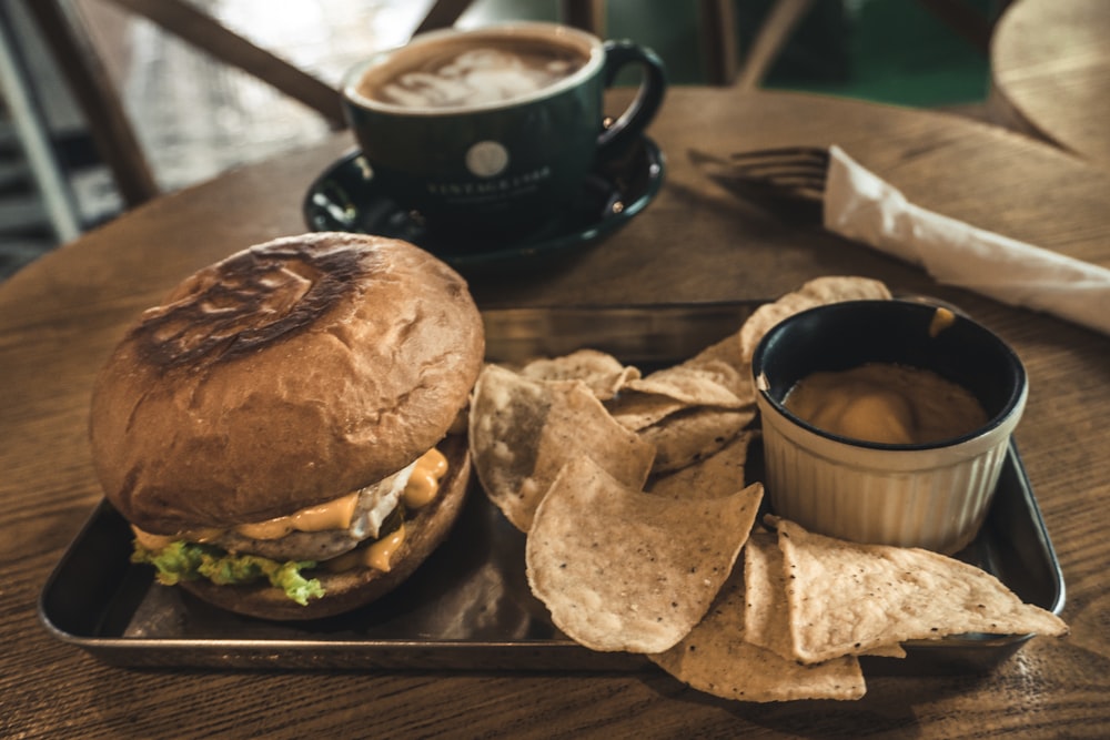 a tray with a sandwich and chips on it