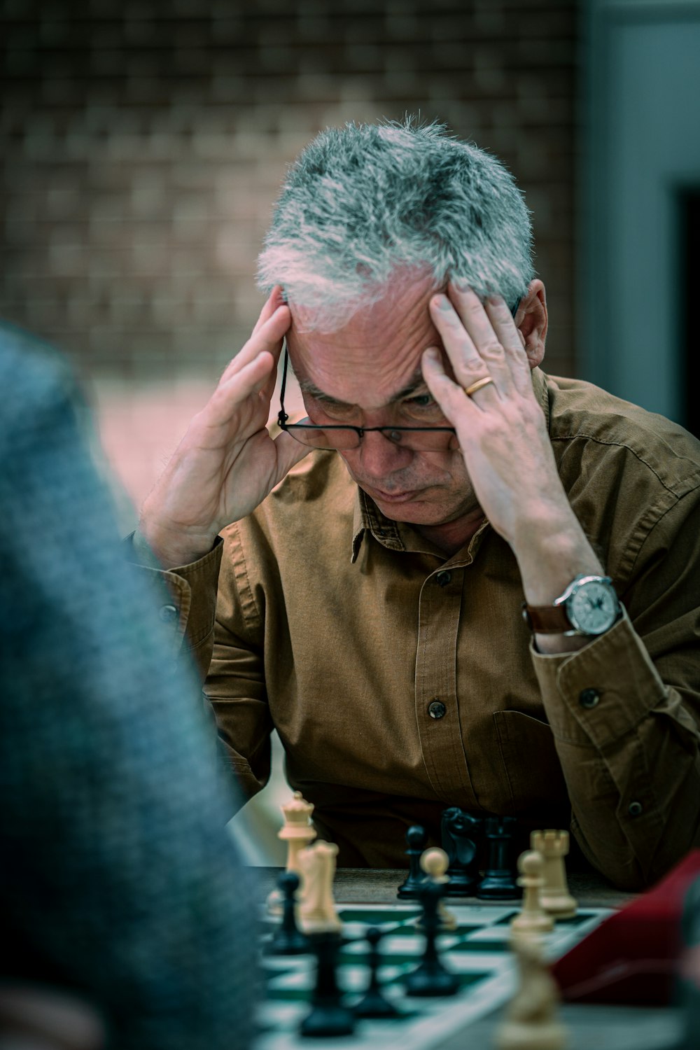 a man sitting at a table playing chess