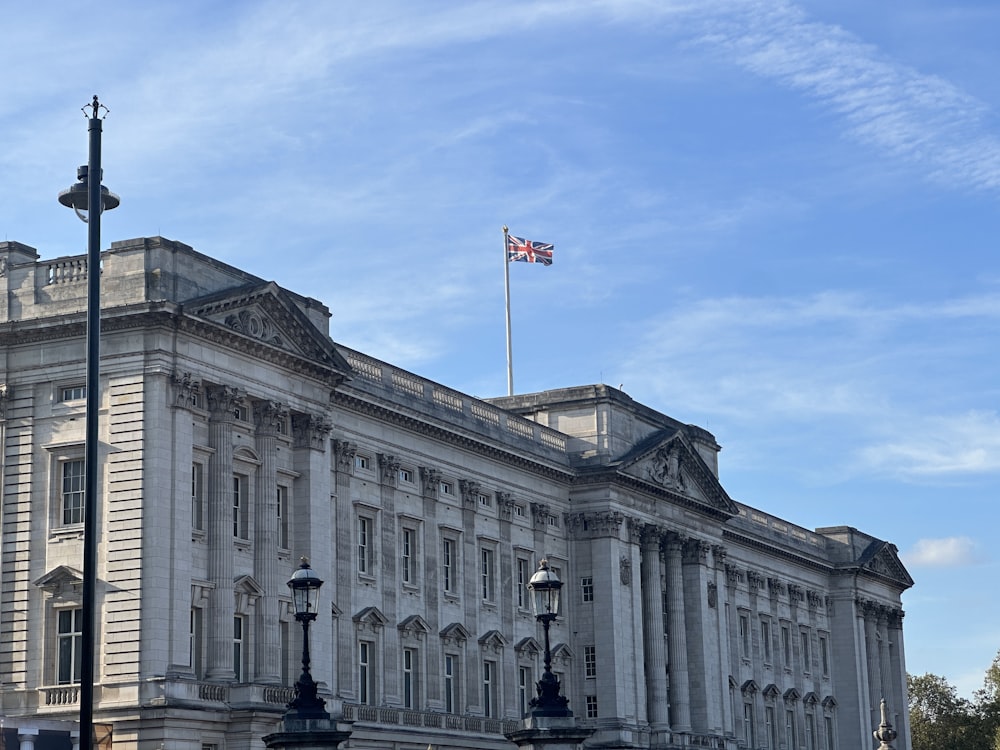 a large white building with a flag on top of it