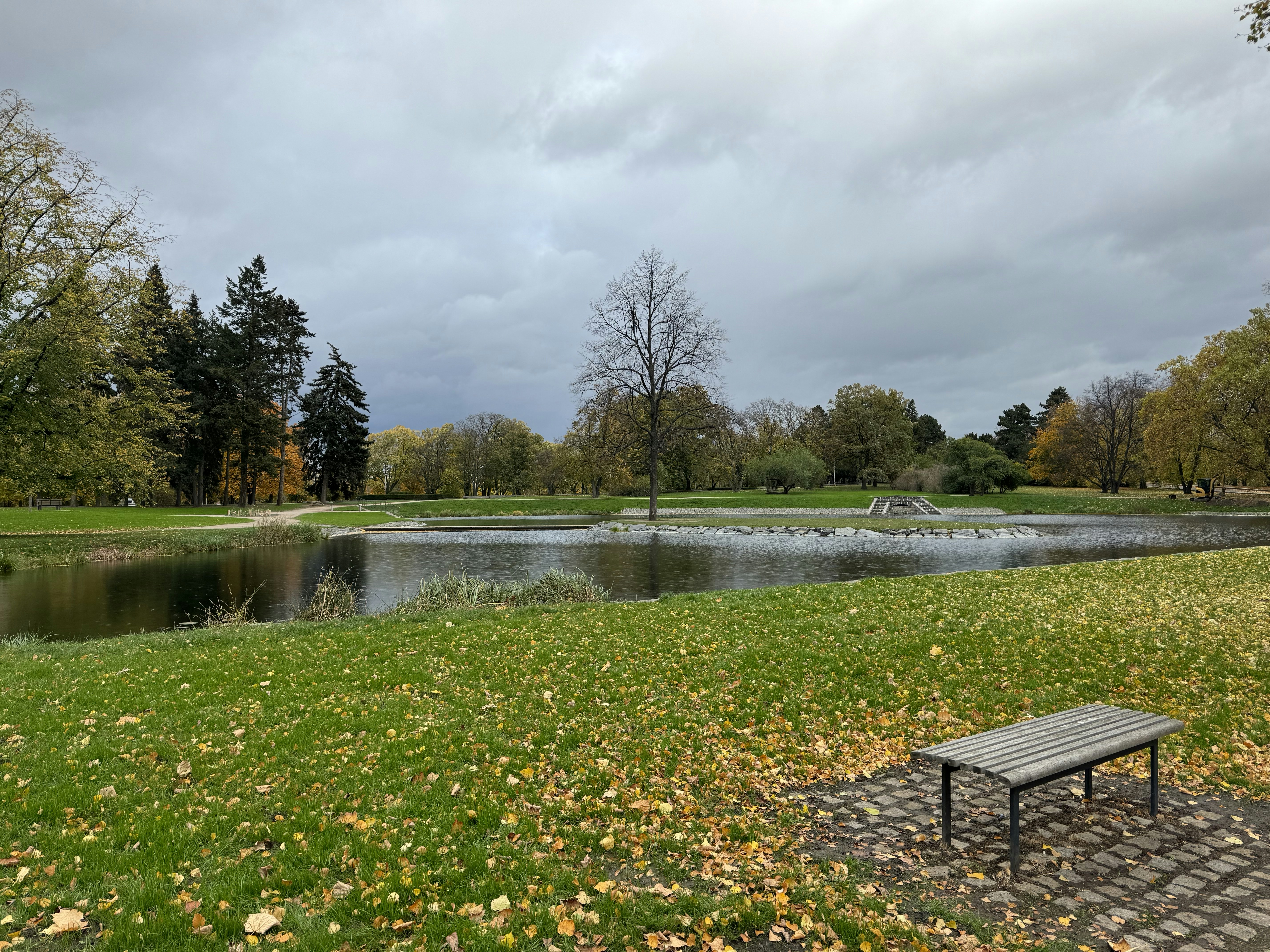a wooden bench sitting on top of a lush green field