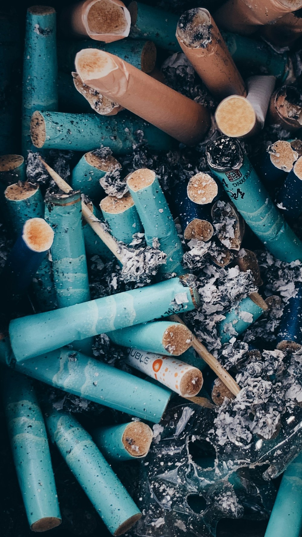 a pile of blue and brown cigarettes sitting next to each other