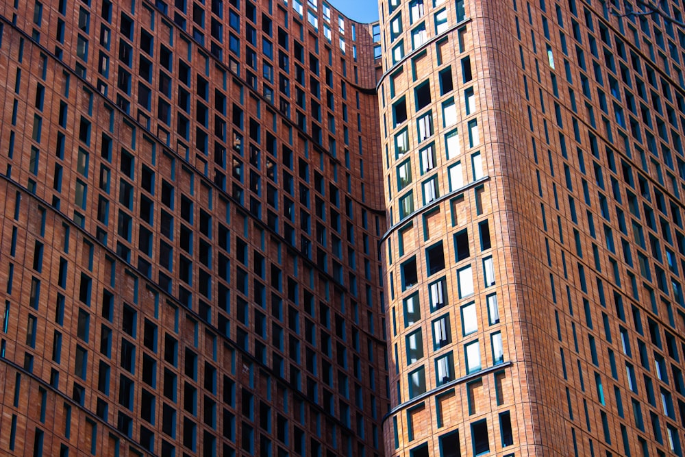 a tall brick building with a clock on the side of it