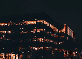 Modern residential building with warm lighting at sunset, inviting and calm atmosphere.