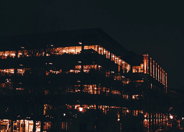 Modern residential building with warm lighting at sunset, inviting and calm atmosphere.