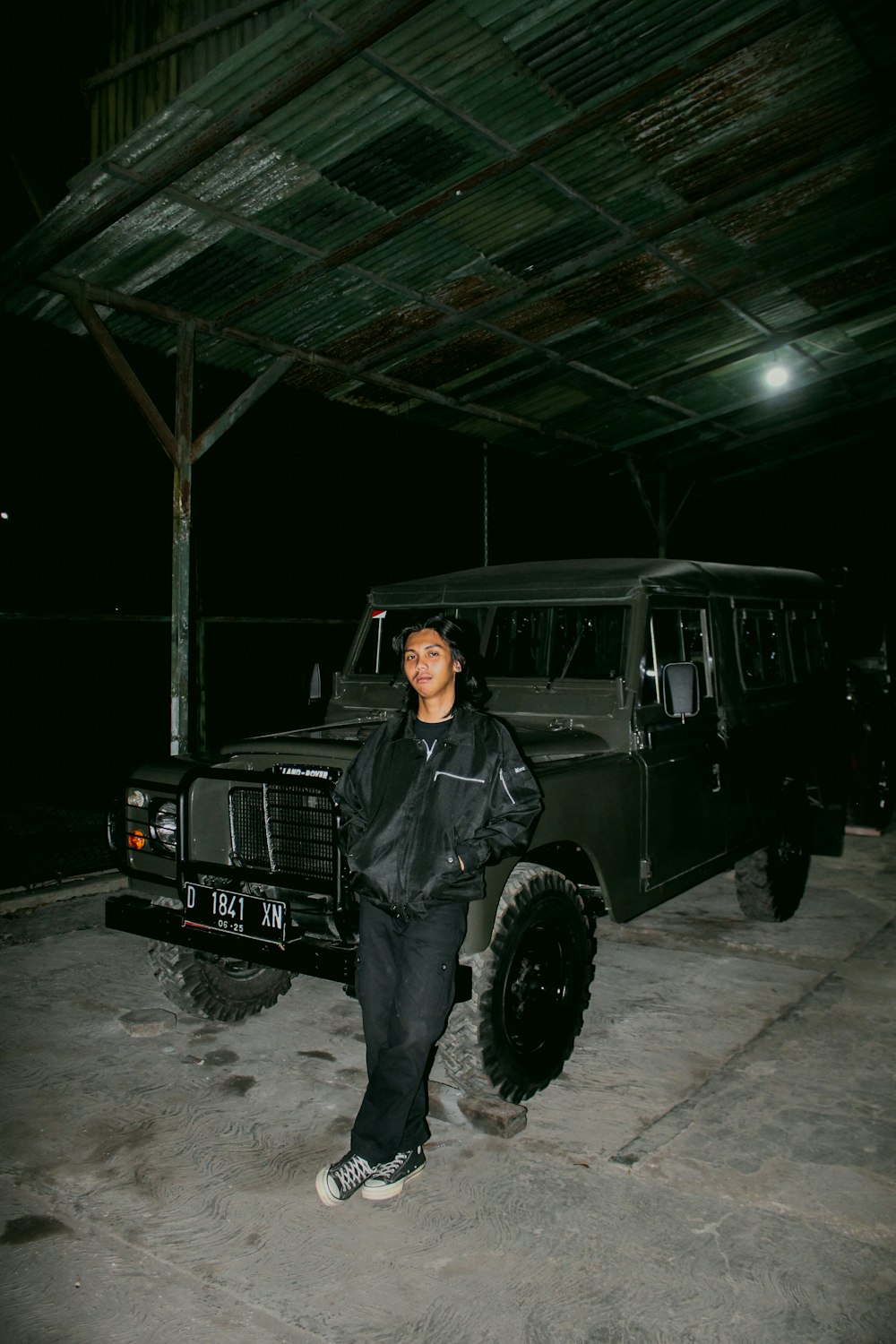 a man standing in front of a black truck
