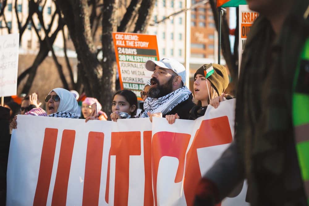 a group of people holding a large sign