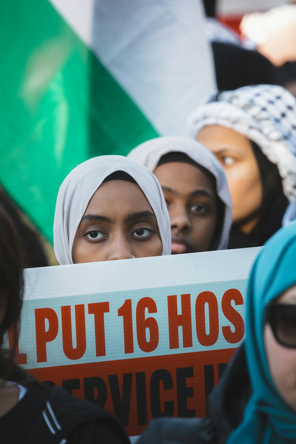 a group of women holding a sign that says put 16 hos service