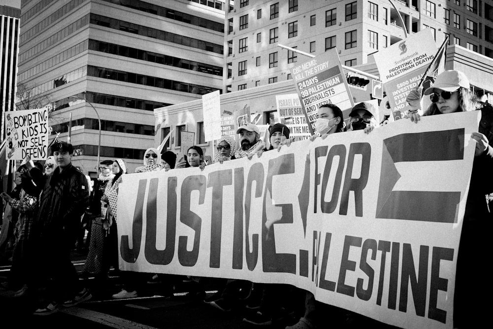 a large group of people holding a protest sign