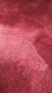 Close-up of a handcrafted product with rich textures and subtle, luxurious tones.