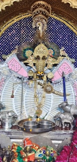 Silver pooja items shimmering under soft light, highlighting their intricate designs.