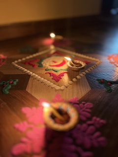 Decorative lamps and rangoli designs outside the temple during festival time.