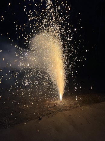 Close-up of a sparkling firework fountain emitting golden sparks