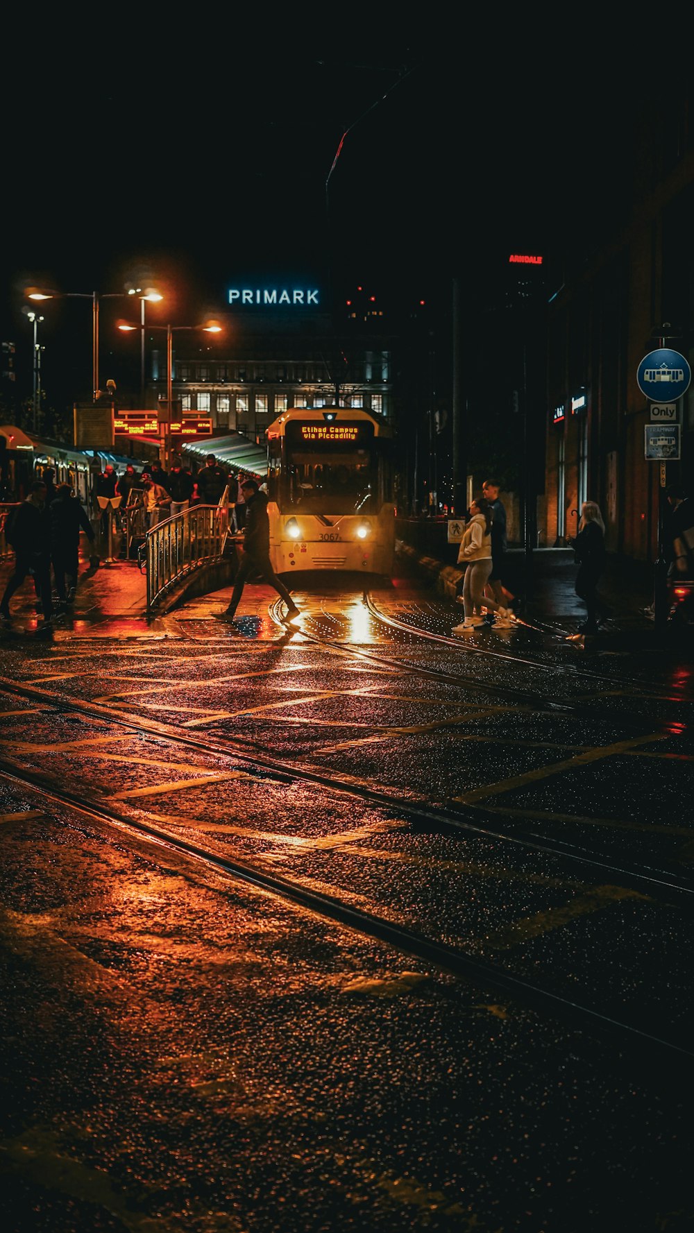 a bus driving down a street at night